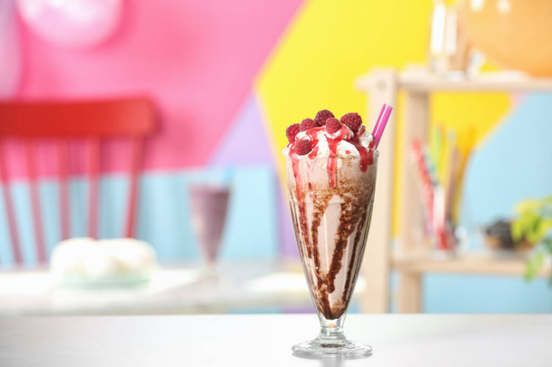 Tasty milk shake with topping on white table indoors. Space for text - Foto, Imagem