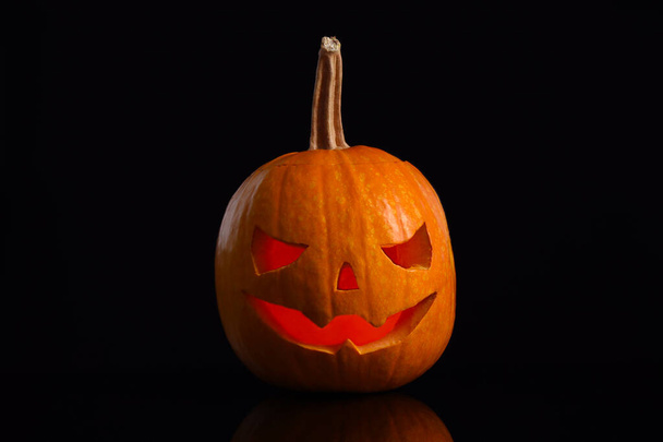 Pumpkin head on black background. Jack lantern - traditional Halloween decor - Zdjęcie, obraz