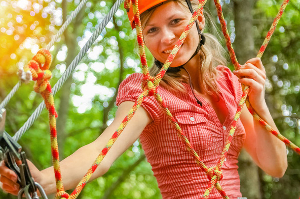 beautiful girl in the park on the ropes achieve Outdoors - Φωτογραφία, εικόνα