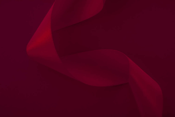 Абстрактная кудрявая шелковая лента на винном фоне, эксклюзивная роскошь
  - Фото, изображение