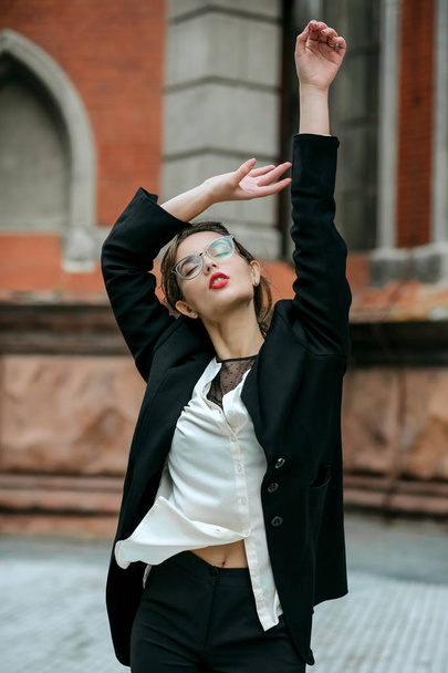 Splendid girl with red lipstick wears costume and glasses  - Zdjęcie, obraz
