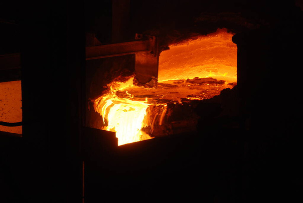 Very rare close view of working open hearth furnace at the metallurgical plant. Molten hot steel - Photo, Image