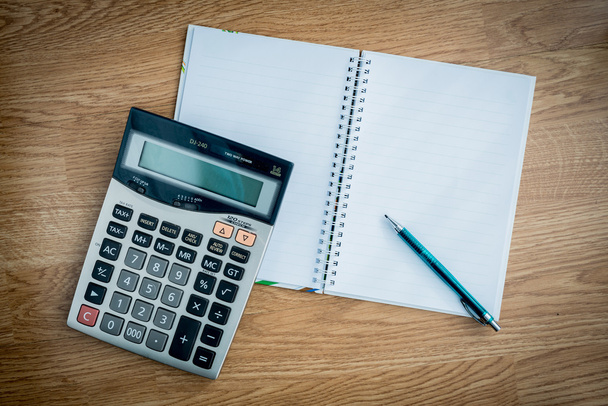 calculator and notebook and pen - Фото, изображение