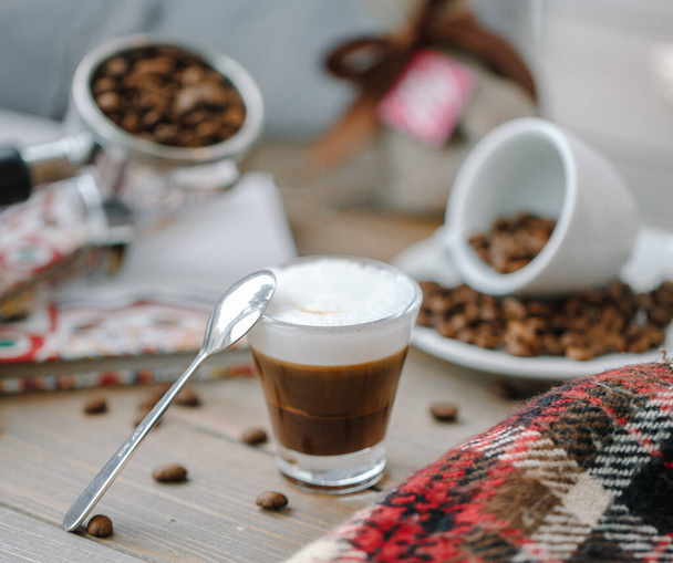 small shot of espresso with spoon decorated with coffee beans - Fotoğraf, Görsel