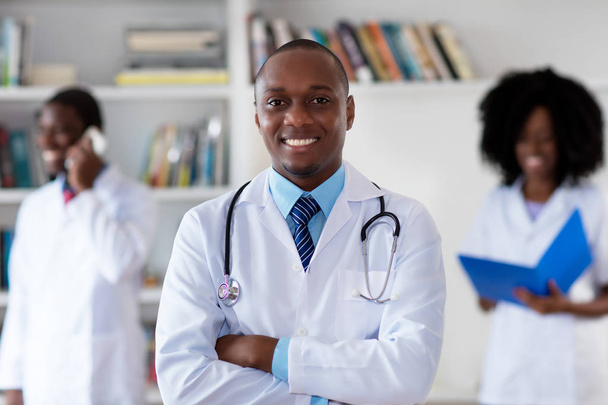 African american mature doctor with medical team - Photo, image
