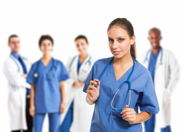 Nurse in front of her medical team - Φωτογραφία, εικόνα