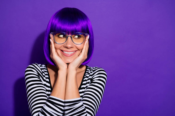 Photo of nice lady hands touch cheekbones look with wonder empty space wear wig striped pullover isolated purple background - Foto, Imagem