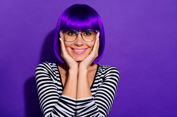 Photo of nice lady hands touch cheeks overjoyed wear wig striped pullover isolated purple background - Foto, afbeelding