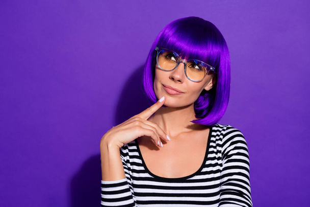 Photo of amazing lady touch chin finger look up empty space wear bright wig striped pullover isolated purple background - Foto, afbeelding