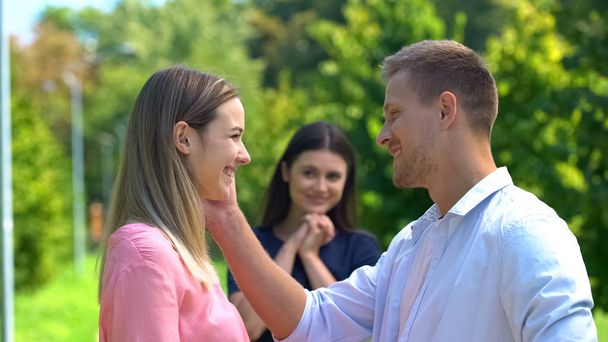Cheerful man and woman smiling each other, happy friend on background, love - Fotoğraf, Görsel