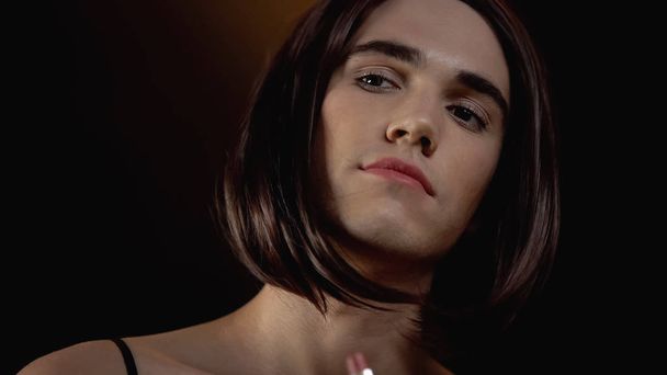 Attractive male transgender putting on makeup before cabaret show, gay fashion - Foto, Imagen