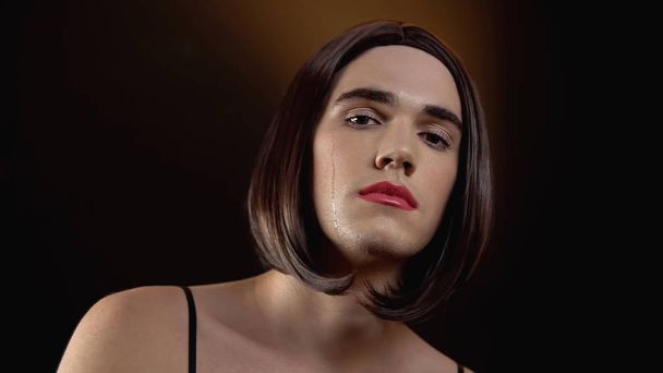 Crying agender in wig with makeup looking at cam, victim of social condemnation - Fotoğraf, Görsel
