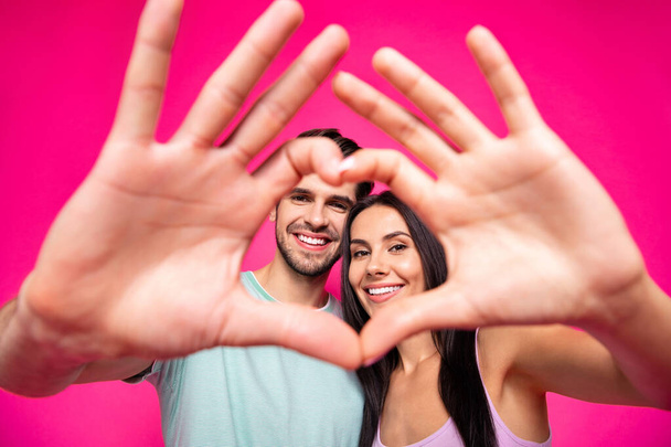 Photo of amazing guy and lady making heart figure with arms located faces inside of it wear casual outfit isolated pink color background - Foto, Imagem