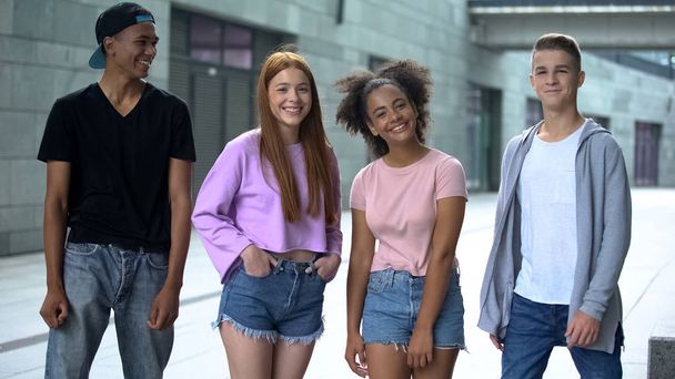 Glad young people smiling on camera outdoors, multiracial friends connection - Zdjęcie, obraz