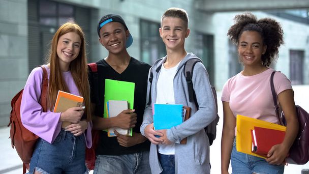 Multiracial high school students with books smiling camera, educational program - Foto, Bild