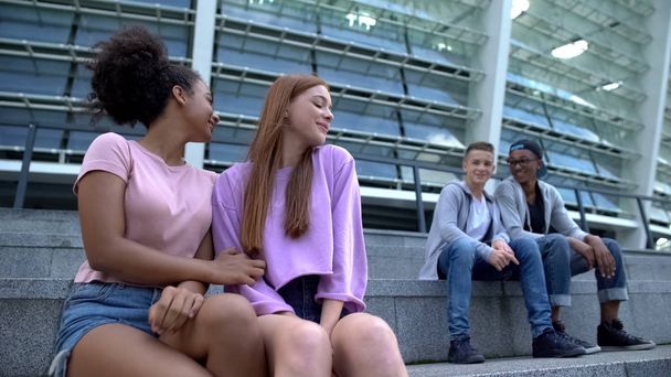 Multiracial couples of teenagers sitting stairs outdoor, romantic youth, leisure - Φωτογραφία, εικόνα