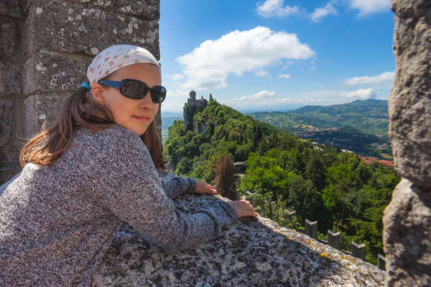 Young tourist girl visiting the sights of San Marino. - 写真・画像