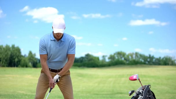 Experienced male golfer hitting ball at course, training before competition - Fotó, kép