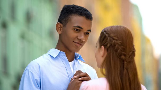 Mixed race boyfriend admiring girlfriend, first sincere feelings, romance - Фото, изображение