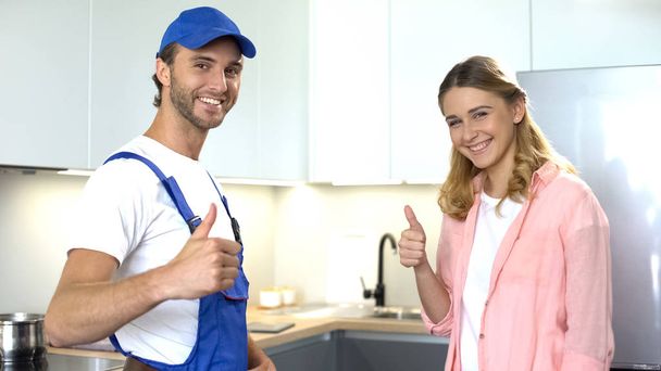 Plumber and happy client showing thumbs up, ad of quality home repair services - Foto, Imagem