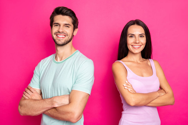 Photo of amazing couple guy and lady standing with crossed arms reliable workers wear casual clothes isolated vibrant pink color background - Zdjęcie, obraz