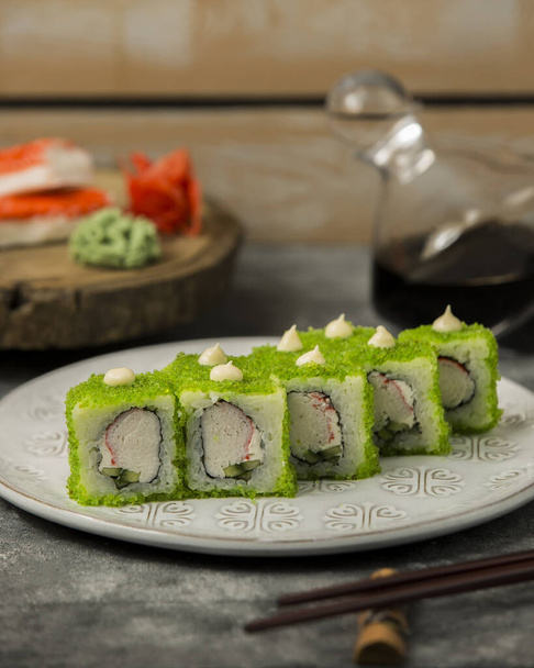 close up of sushi set with crab sticks, cucumber, covered in green tobiko - Foto, Imagen