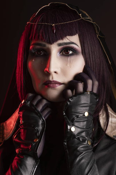 A beautiful busty cosplay girl wearing an erotic leather costume - Fotoğraf, Görsel