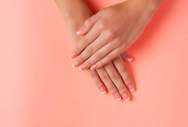 French manicure on the young hands of a girl. Flat lay photo, with place for text. - Zdjęcie, obraz