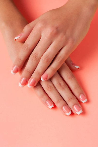 French manicure on the young hands of a girl. Flat lay photo, with place for text. - Foto, Bild