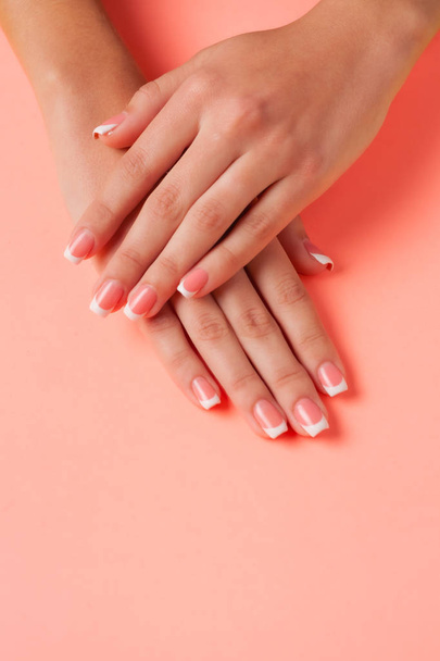 French manicure on the young hands of a girl. Flat lay photo, with place for text. - Foto, Imagen