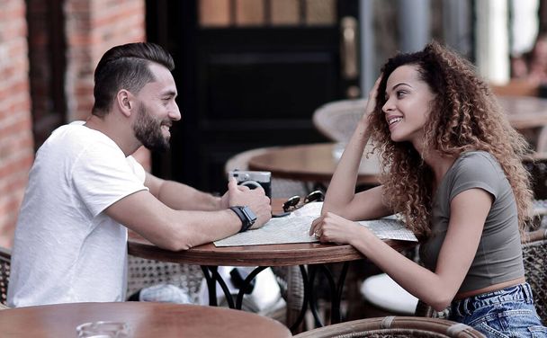 Beautiful loving couple sitting in a cafe enjoying in coffee - 写真・画像