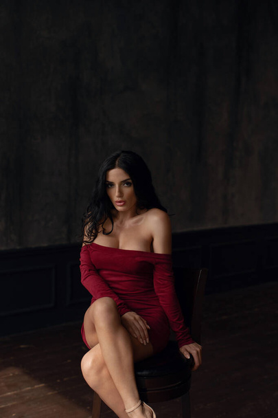 Young sexy brunette in a red dress. - Foto, Imagem