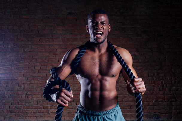 multiethnic bare sexy chest sportsmen exercising with battle ropes at the gym - Foto, Bild