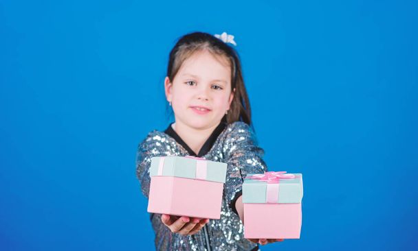 Black friday. Shopping day. Cute child carry gift boxes. Surprise gift box. Birthday wish list. World of happiness. Special happens every day. Choose one. Girl with gift boxes blue background - Photo, Image