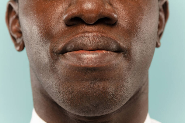 African-american young mans close up portrait on blue background - Фото, зображення