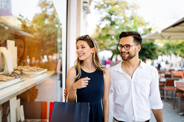 Consumismo, amor, namoro, conceito de viagem. casal feliz gostando de fazer compras se divertindo
 - Foto, Imagem