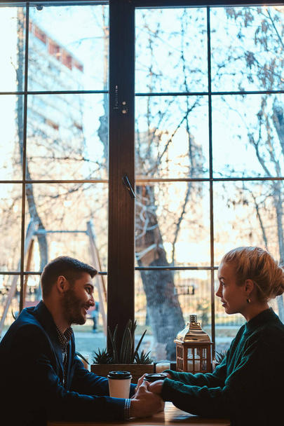 Romantic couple is sitting at cafe at their date - Valokuva, kuva