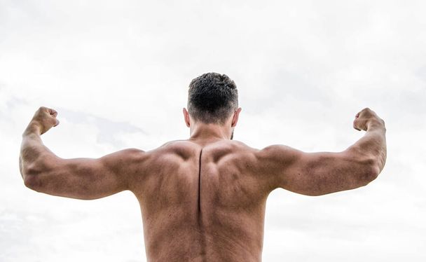 i can do everything. Man with muscular body. Man or sportsman flexing arms with fists, back view. muscular back man isolated on white. Success concept. Strong muscles and power - Foto, afbeelding