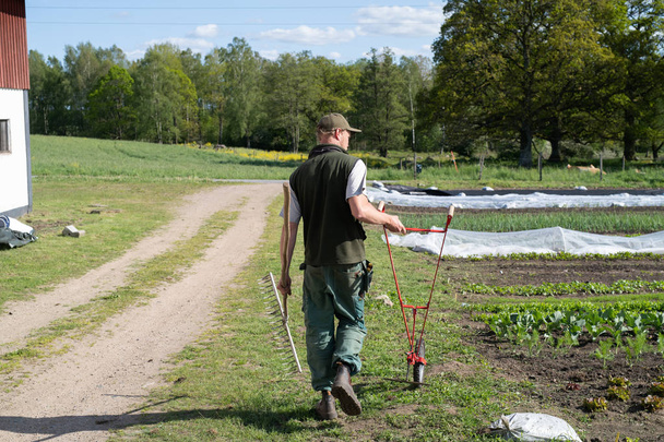 Agricultor trabajando en un jardín
 - Foto, Imagen