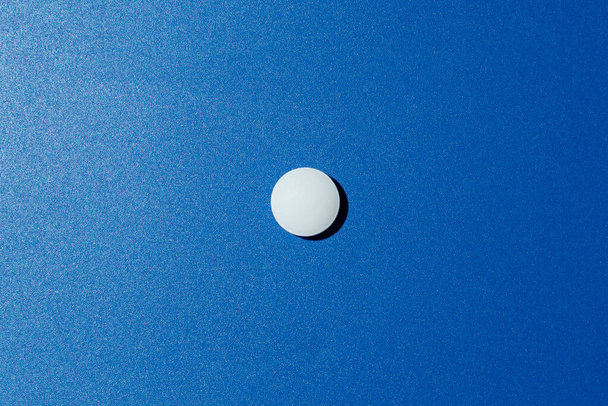 Slide of white tablets on a light table. - Photo, Image