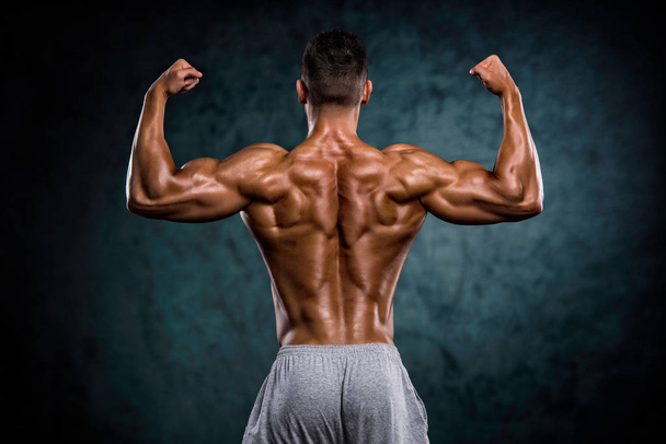 Strong Muscular Men Flexing Muscles - Photo, Image