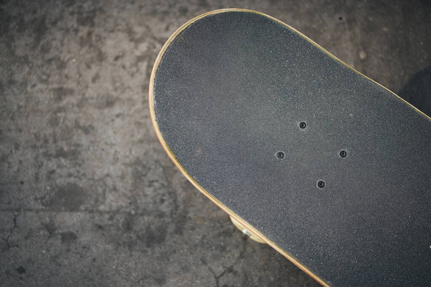 Top view of skateboard in concrete skatepark on warm day - Foto, Imagen