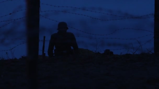 Żołnierz II Wojny Światowej siedzi nocą w okopie na patrolu. - Materiał filmowy, wideo