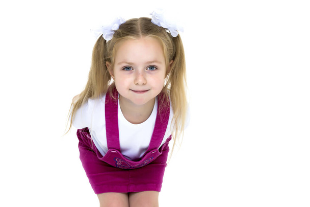 Little girl posing in studio on a white background. - Фото, изображение