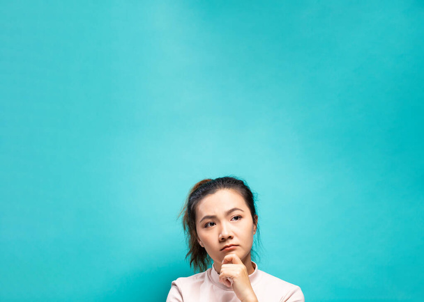 Portrait of serious woman on a blue background - Photo, Image