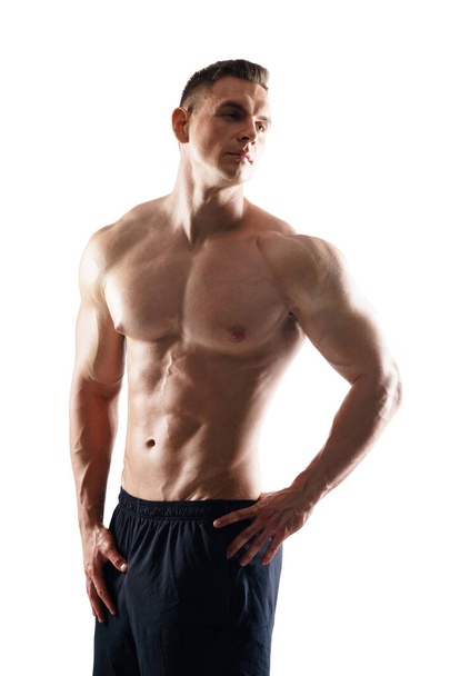 Strong, fit and sporty bodybuilder man over white background. Sport and fitness. - Φωτογραφία, εικόνα