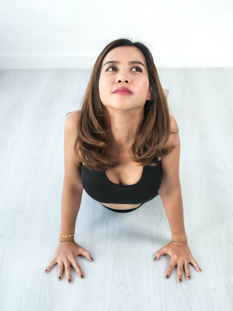 Asian sport woman doing yoga at home, lifestyle concept. - Photo, image