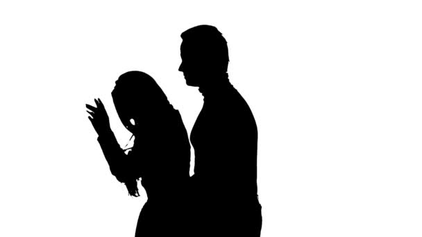 Loving couple kisses and dances together. Silhouette. White background. Slow motion. Close up - Imágenes, Vídeo