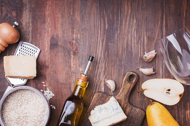 Ingredients for cooking risotto with pear and gorgonzola cheese on wooden table - Фото, изображение