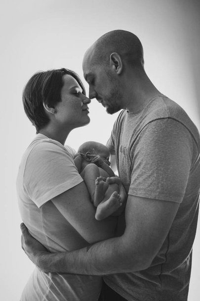 family photo on a white background: parents spend time with their children. mom and dad hug the baby. the concept of childhood, fatherhood, motherhood, IVF - Fotoğraf, Görsel